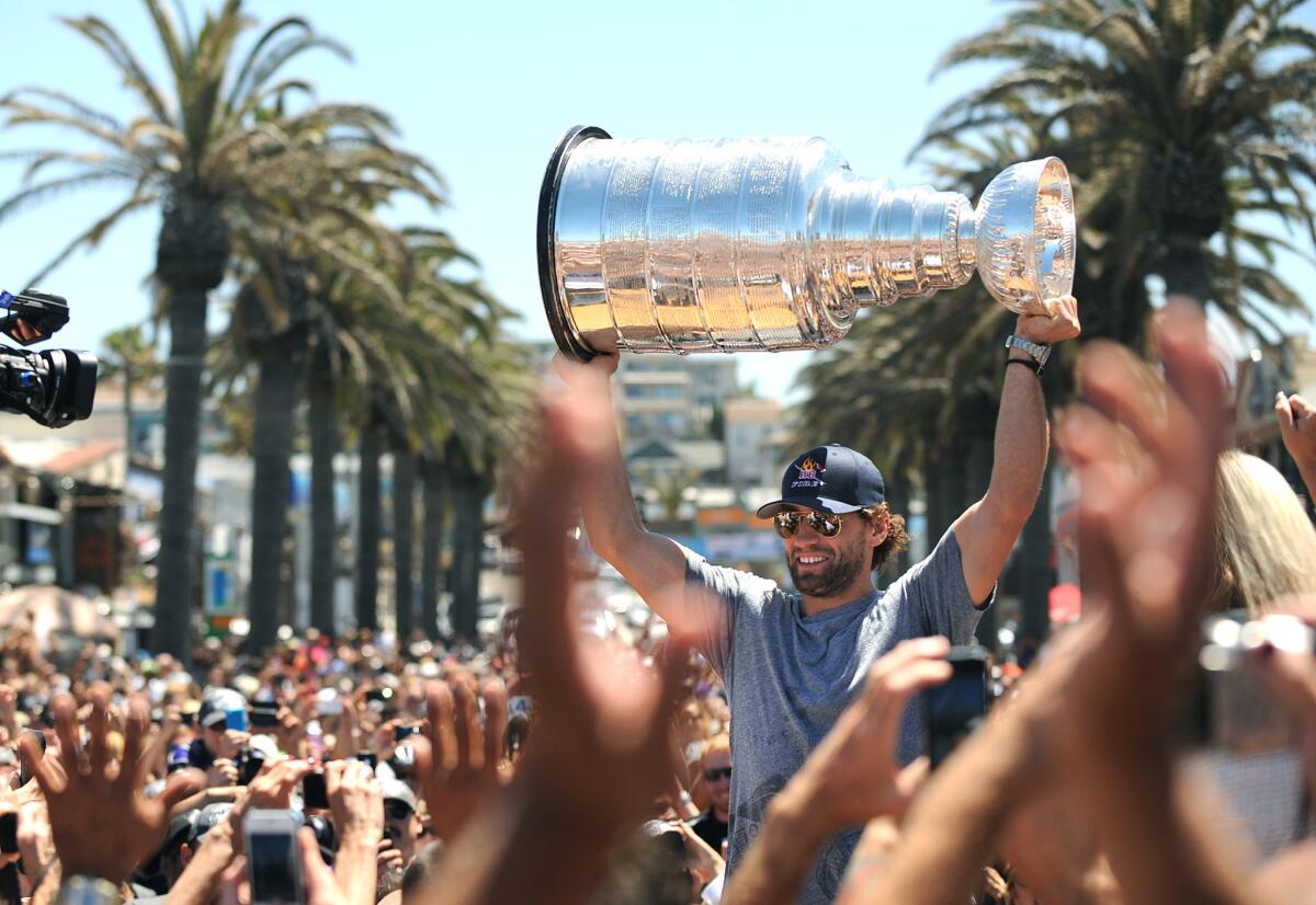 Kings center Jarret Stoll raises the Stanley Cup along The Strand in Hermosa Beach two years ago, during a South Bay victory parade celebrating their 2012 championship.