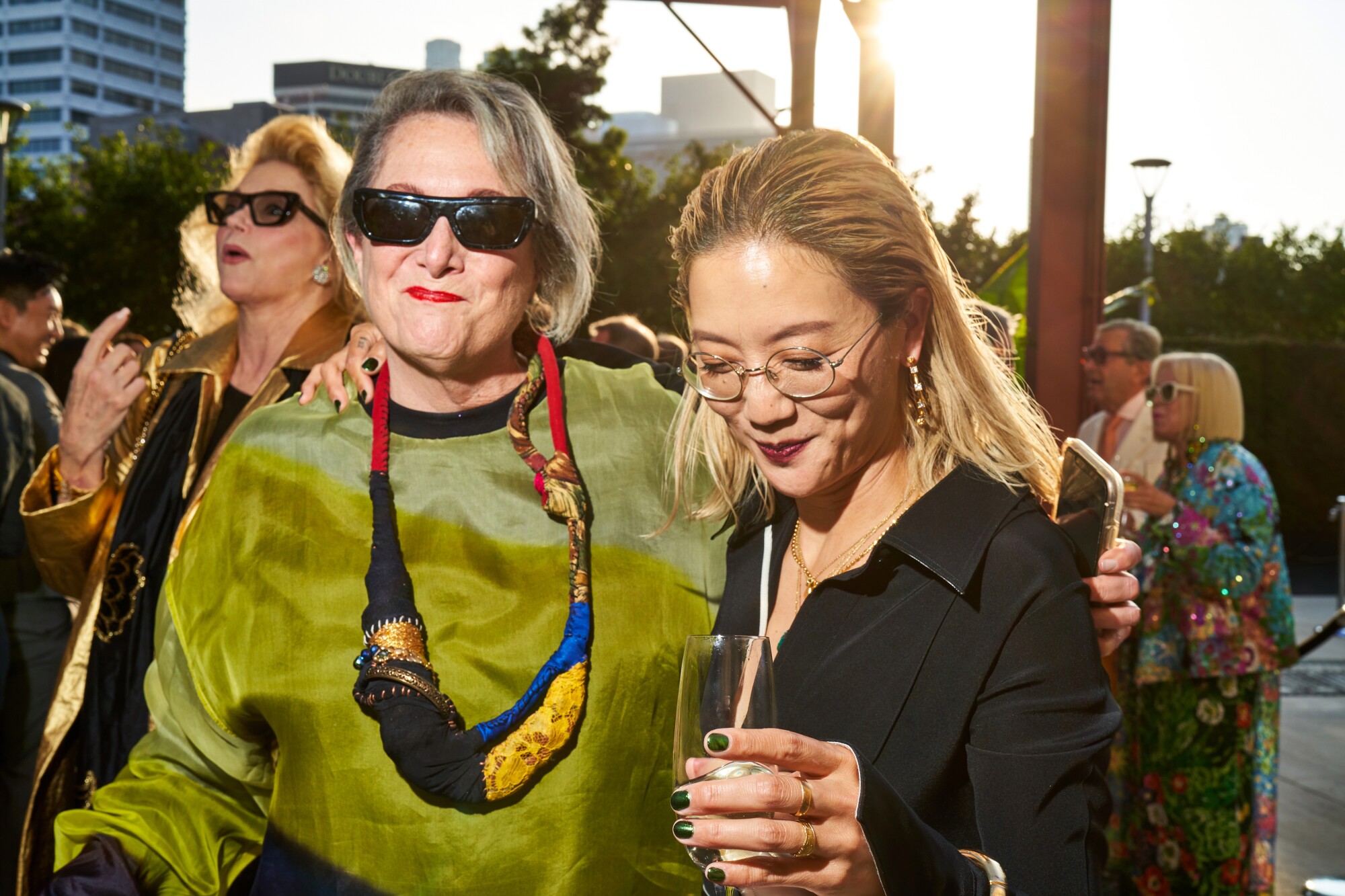 MOCA board member Deborah Irmas, left, grins with Christine Sun Kim in what appears to be the middle of a hilarious joke.