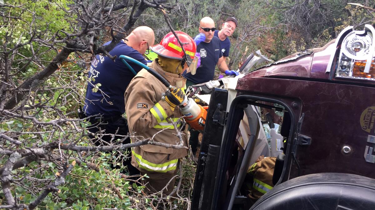 Firefighters work to extricate a 50-year-old man from his crashed vehicle on Mingus Mountain in central Arizona.