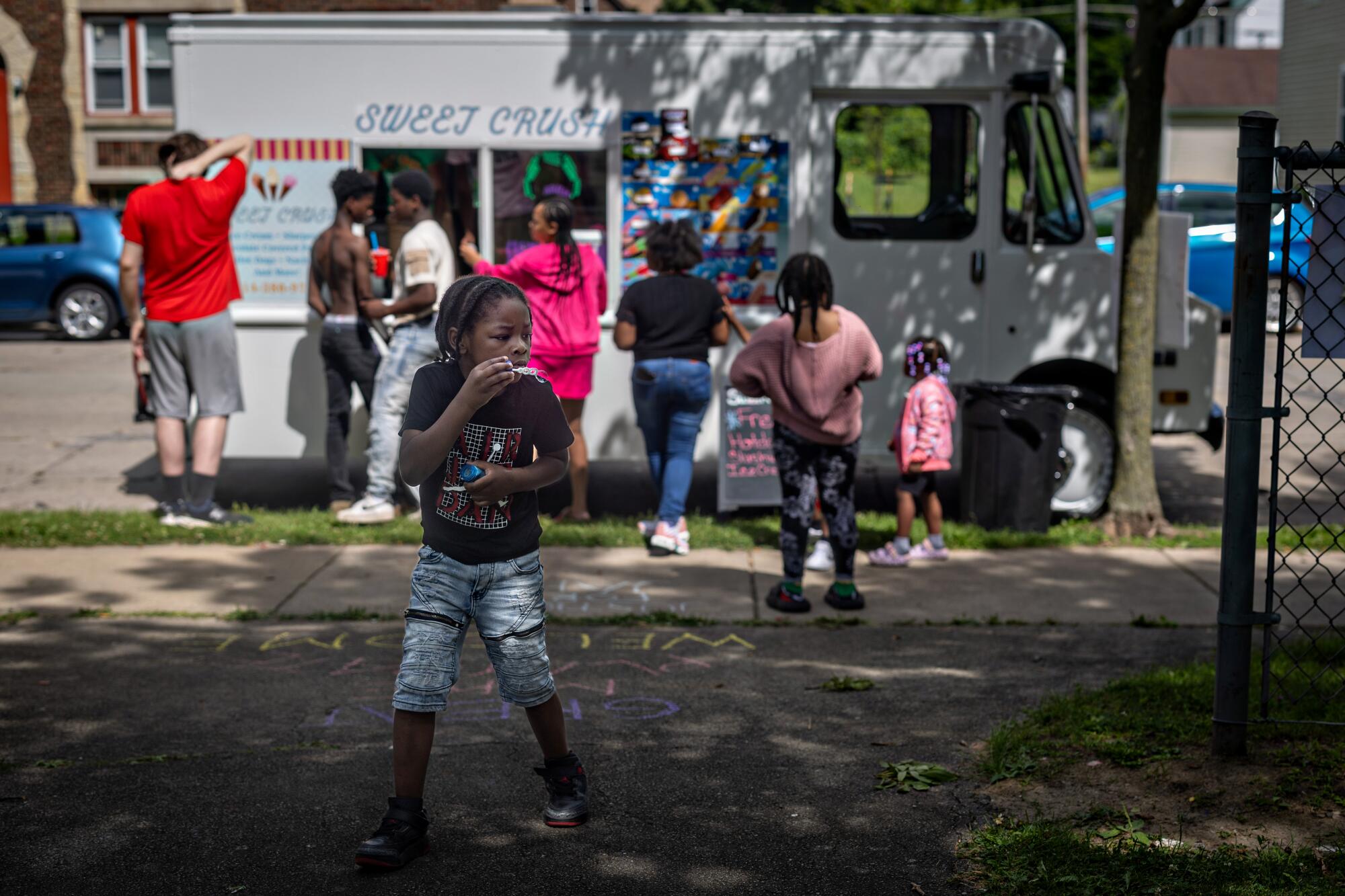 Kids gather for free ice cream at the Milwaukee Childcare Collective event.
