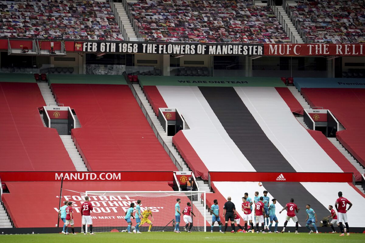Empty stands are seen as Manchester United's Paul Pogba (6) shoots a free kick during the English Premier League soccer match between Manchester United and Bournemouth at Old Trafford stadium in Manchester, England, Saturday, July 4, 2020. (Dave Thompson/Pool via AP)
