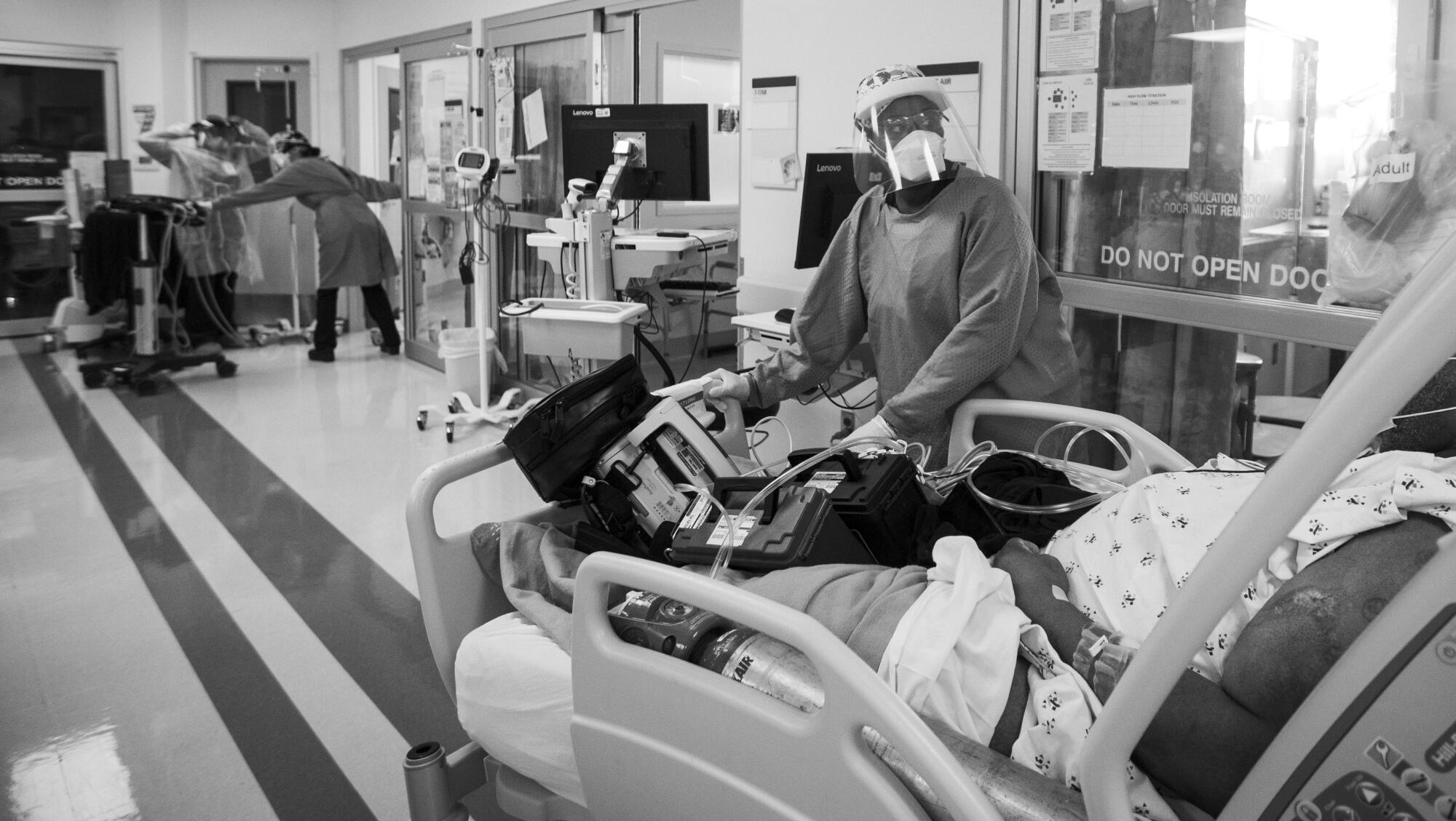 Nurse Quinnece Washington rushes a COVID-19 patient into the intensive care unit.