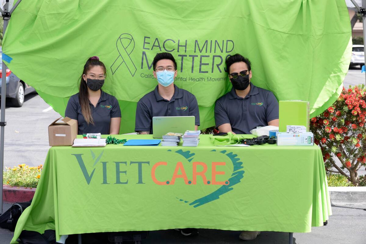 Members of Viet-CARE sit at a table.