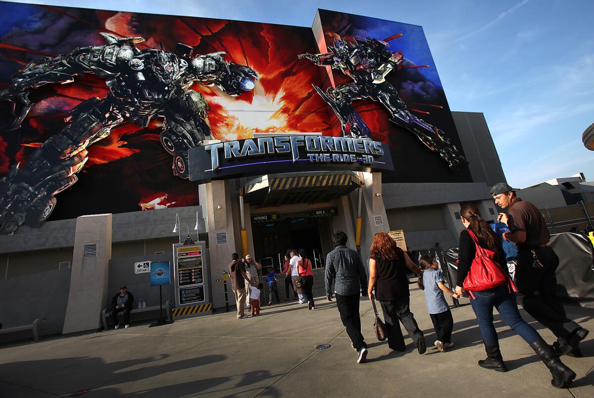 Guests walk into Transformers: The Ride 3D at Universal Studios Hollywood last year.