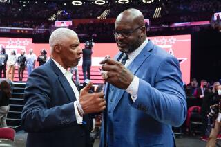 Former NBA stars Julius Erving, left, and Shaquille O'Neal talk court side during the skills challenge competition, part of NBA All-Star basketball game weekend, Saturday, Feb. 19, 2022, in Cleveland. (AP Photo/Charles Krupa)