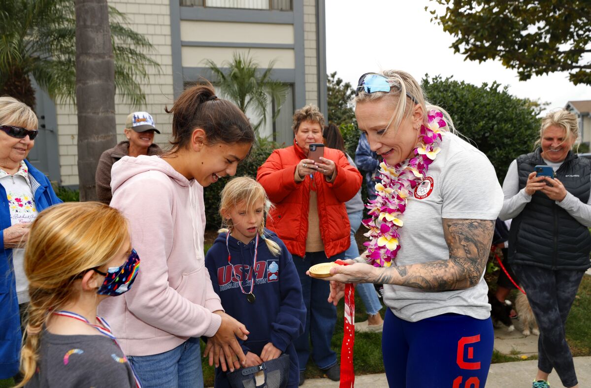 Winter Olympics gold-medal winner Kaillie Humphries is greeted by neighbors Monday in Carlsbad.