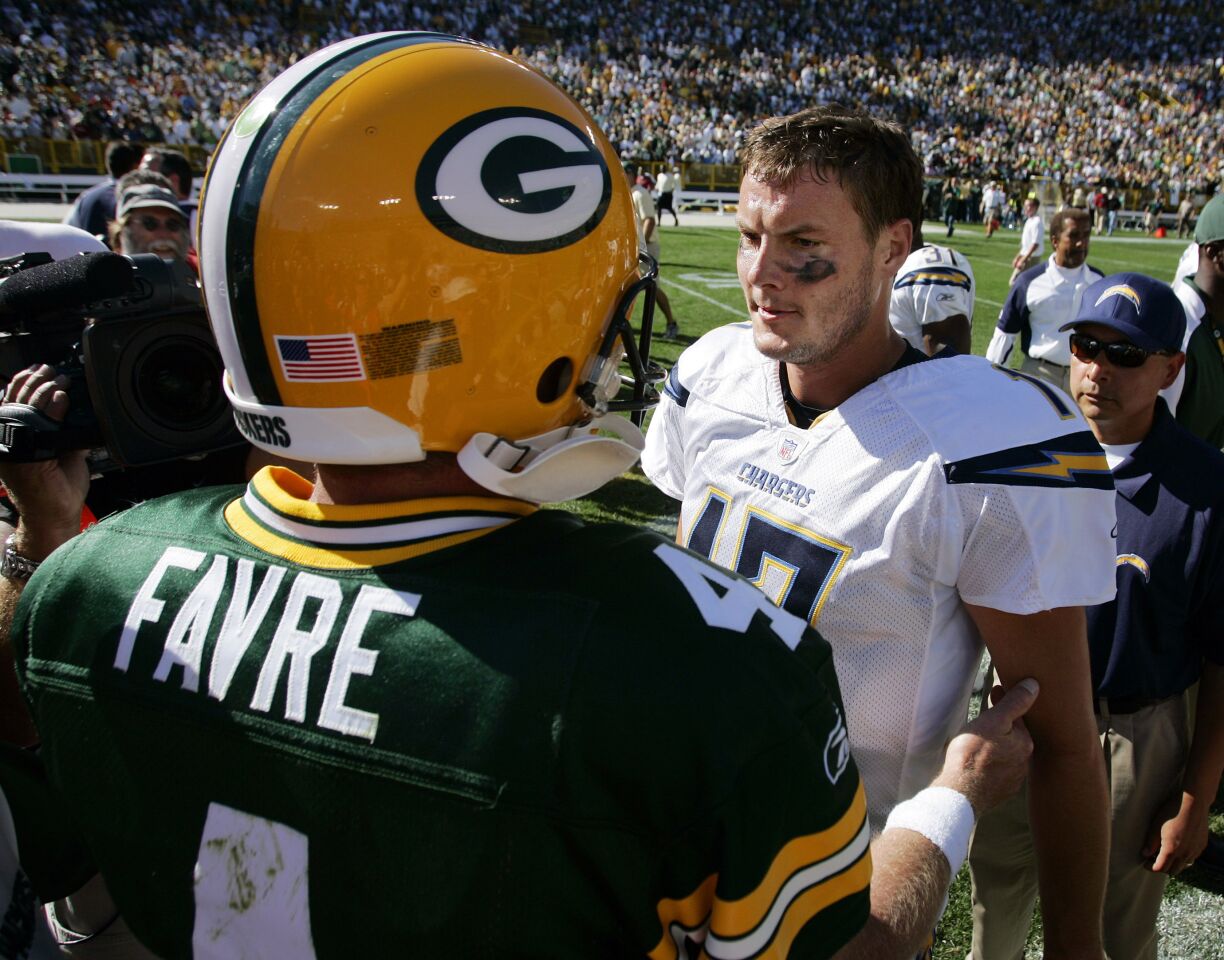 Chargers Philip Rivers and Packers Brett Favre meet after a game in Green Bay on Sept. 23, 2007.