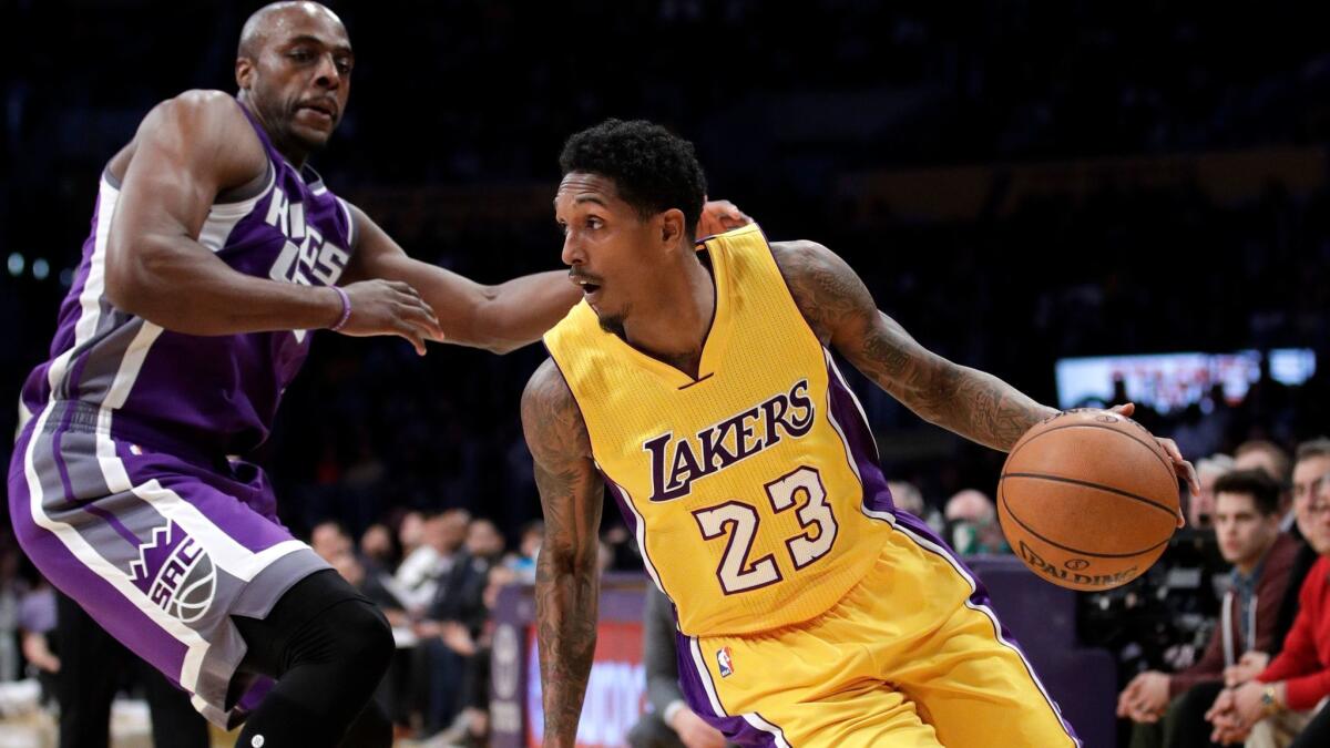 Lou Williams drives past Sacramento's Anthony Tolliver in the first half Tuesday.