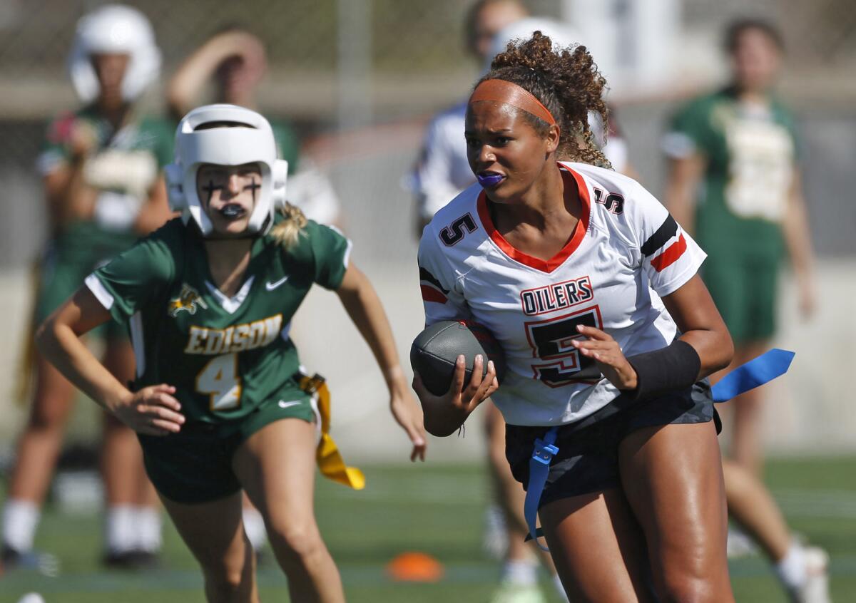 Jaiden Anderson (5) of Huntington Beach runs for a big gain after a catch during Wednesday's game.