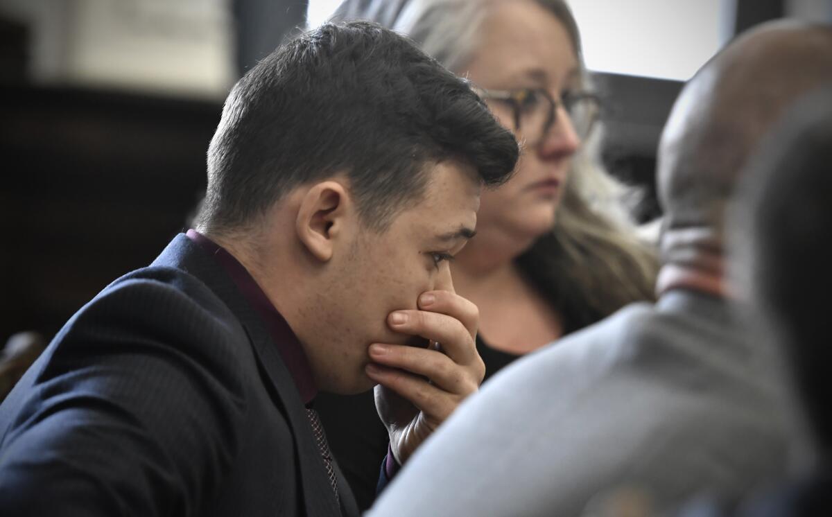 Kyle Rittenhouse puts his hand over his face after he is found not guilty