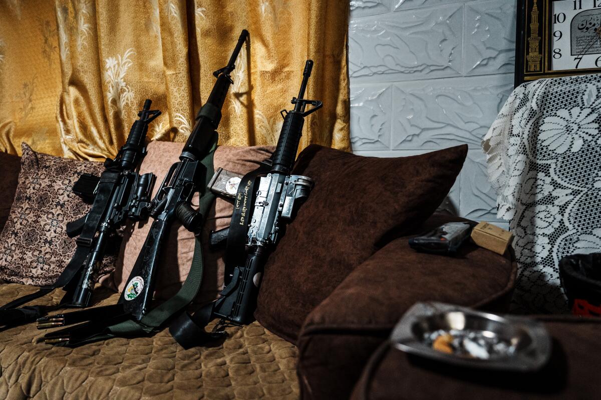 Palestinian fighters' weapons sit inside a home in Jenin, in the occupied West Bank.