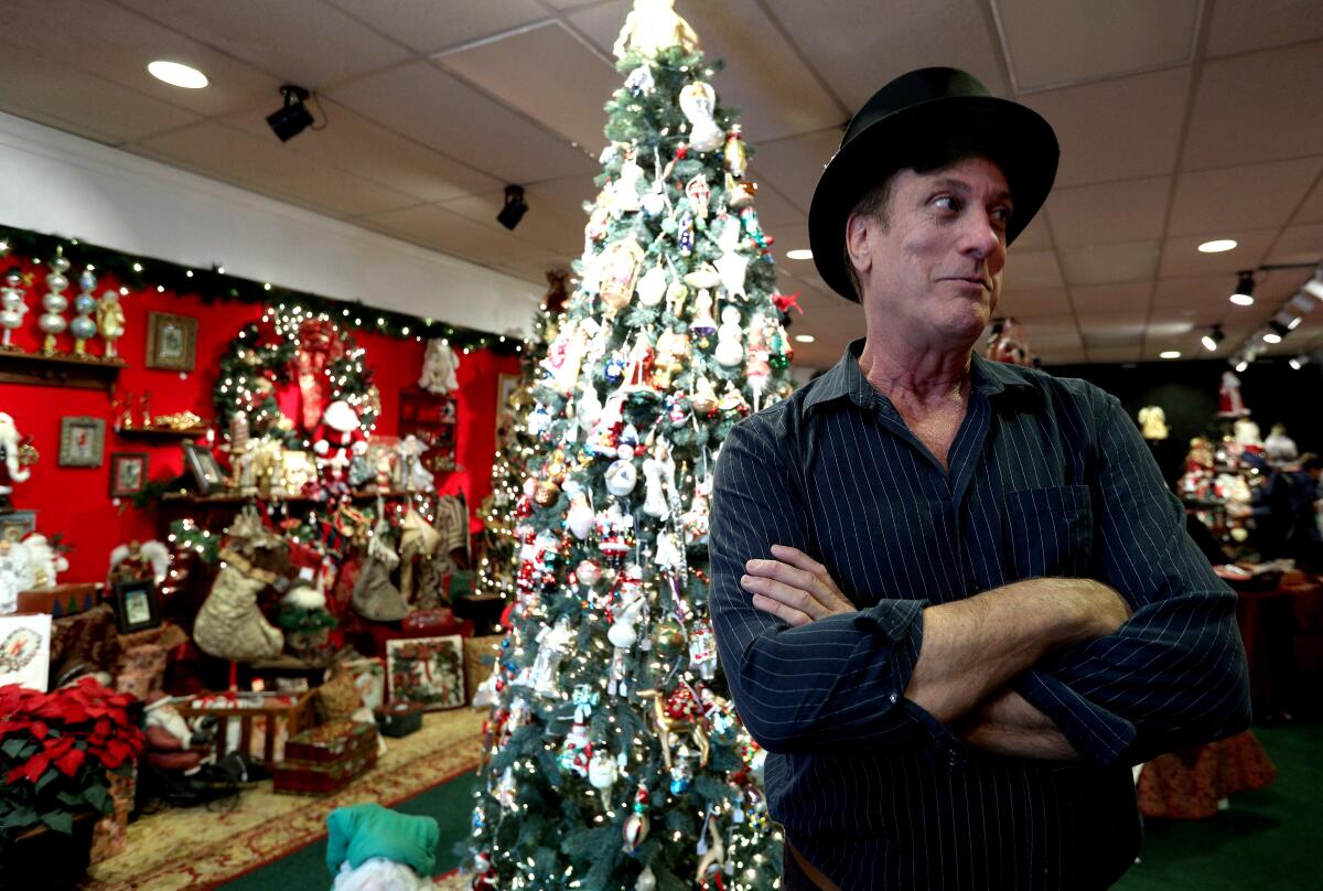 Kristopher Kyer talks about his memorabilia store Christmas Corner, located on the 3500 block of W. Magnolia Ave., in Burbank on Thursday Kyer has operated his Christmas pop-up store on and off for the last 16 years, but he says this may be his last year in the popular shopping district.