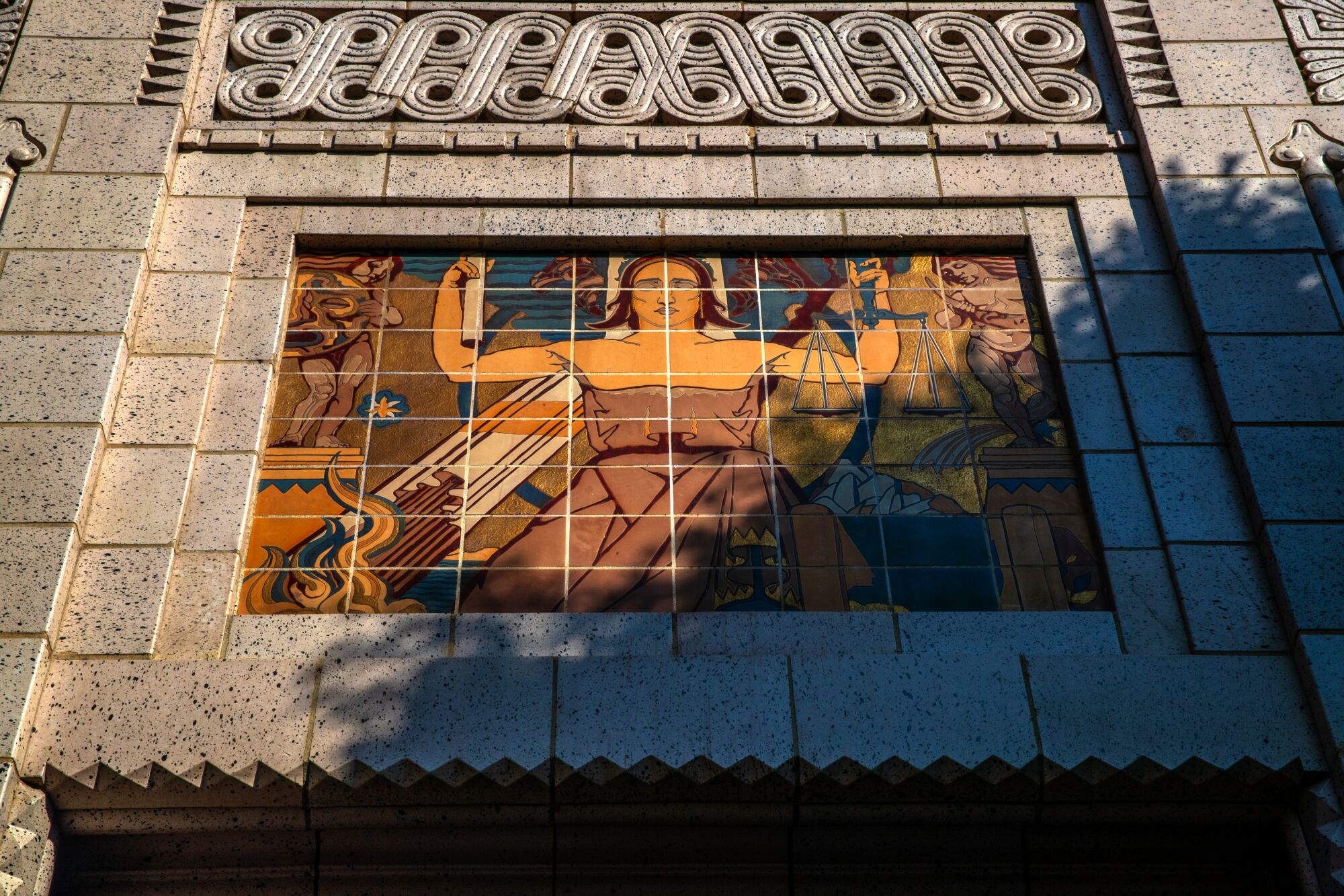 A tile mural of a woman on the façade of  the historic Trust Building in downtown Los Angeles. 