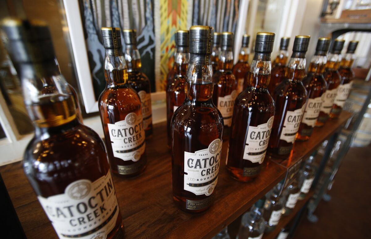 FILE - In this June 20, 2018 file photo, Catoctin Creek Distillery whiskey is on display in a tasting room in Purcellville, Va. A new spirits industry report says President Donald Trump's trade war dampened the overseas market for American-made whiskey last year. The Distilled Spirits Council says overall exports of bourbon, Tennessee whiskey and rye whiskey tumbled amid a trade war-induced decline in exports to key European markets. (AP Photo/Steve Helber, File)