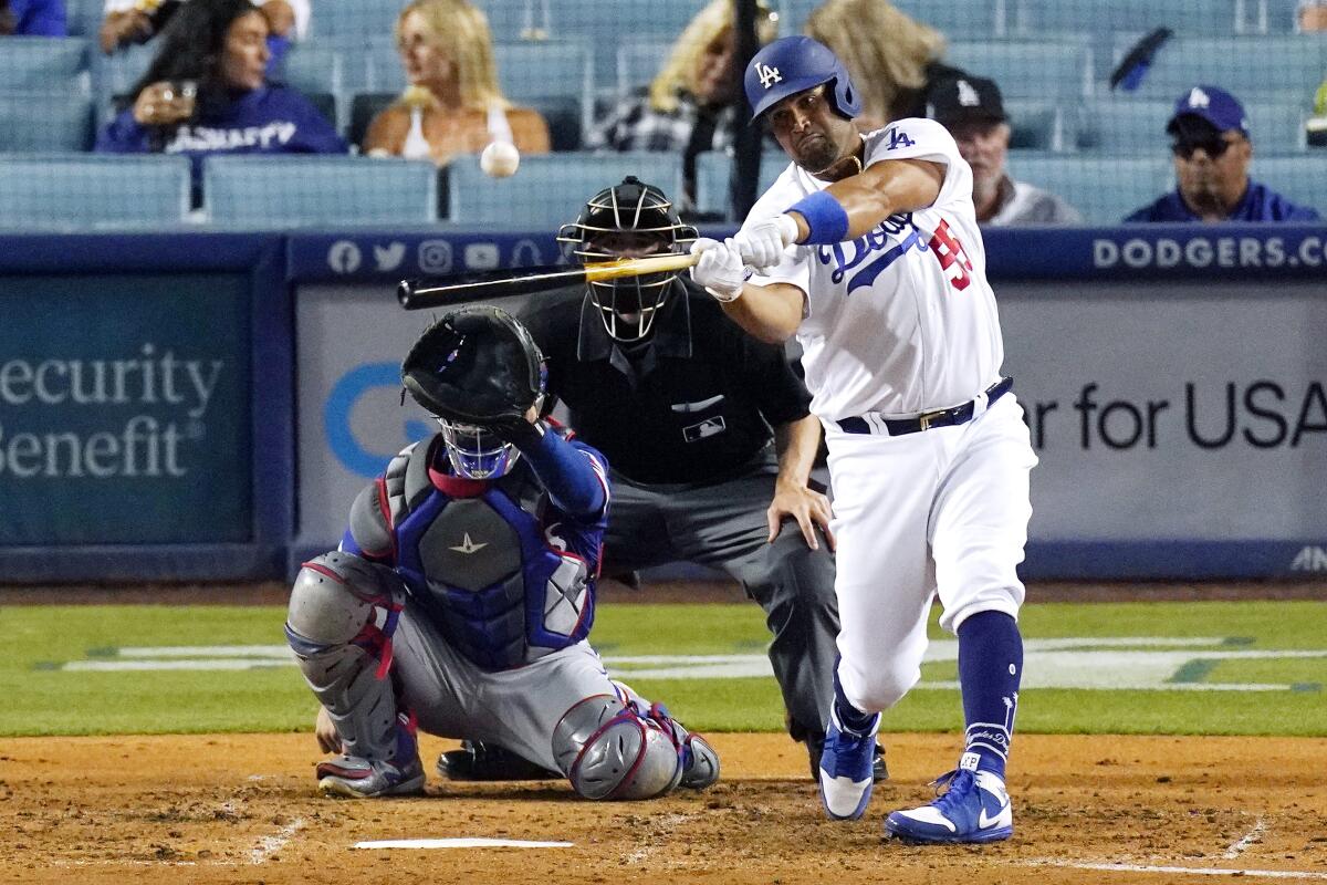 Dodgers first baseman Albert Pujols hits a solo home run during the fourth inning.