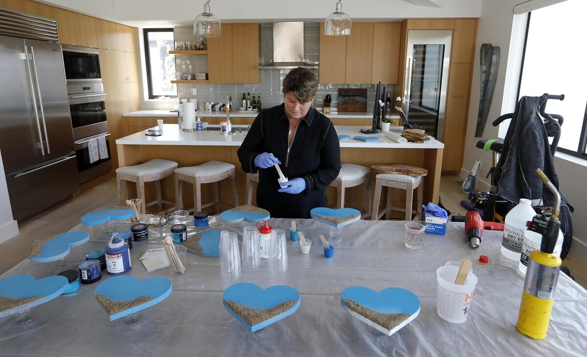 Artist Christie Smith works in her sometimes living room studio in her home in Laguna Beach.