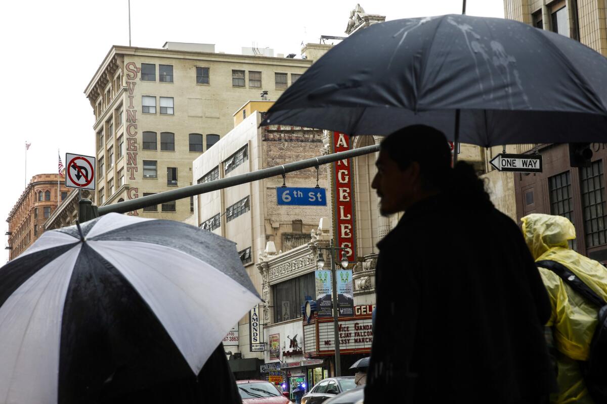 The umbrellas were out on March 1 as people made their way down Broadway in downtown Los Angeles.