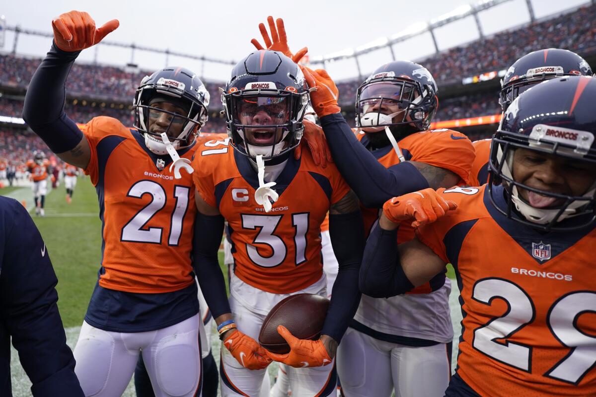 Denver Broncos free safety Justin Simmons celebrates after intercepting a pass against Washington.