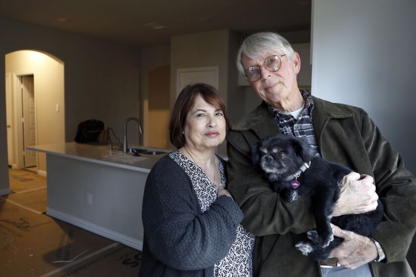 MCKINLEY, TEXAS OCTOBER 29, 2019 -- Conservatives Judy Stark and her husband, Richard Stark, with their dog, Zoey, look around the new home they bought in a suburban neighborhood in McKinney, Texas on Tuesday, October 29, 2019. The Trump supporters are moving from California to Texas because they feel like the state's politics have pushed them to leave. (Lara Solt / For The Times)