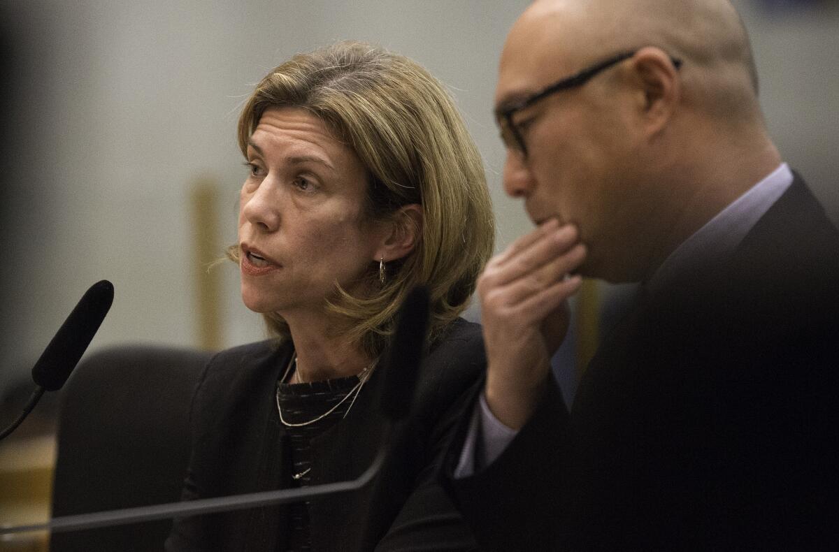 Gillian Wright, SoCalGas vice president of customer services, and Jimmie Cho, senior vice president of gas operations and system integrity, answer questions from county Board of Supervisors on Aliso Canyon natural gas leak during a meeting in Los Angeles on Tuesday. The leak was reported Oct. 23 and has been sickening area residents for over a month.