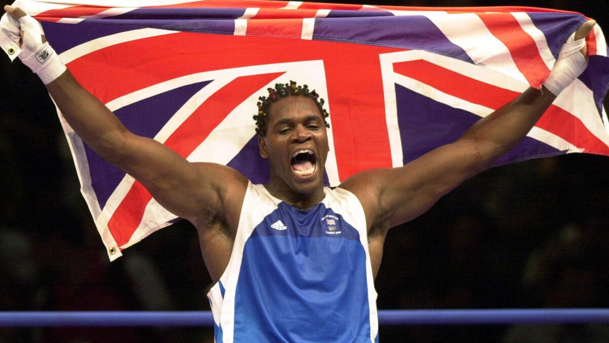 British boxer Audley Harrison celebrates his super-heavyweight gold medal victory at the 2000 Sydney Summer Olympics. Harrison has retired from boxing because of brain injuries.