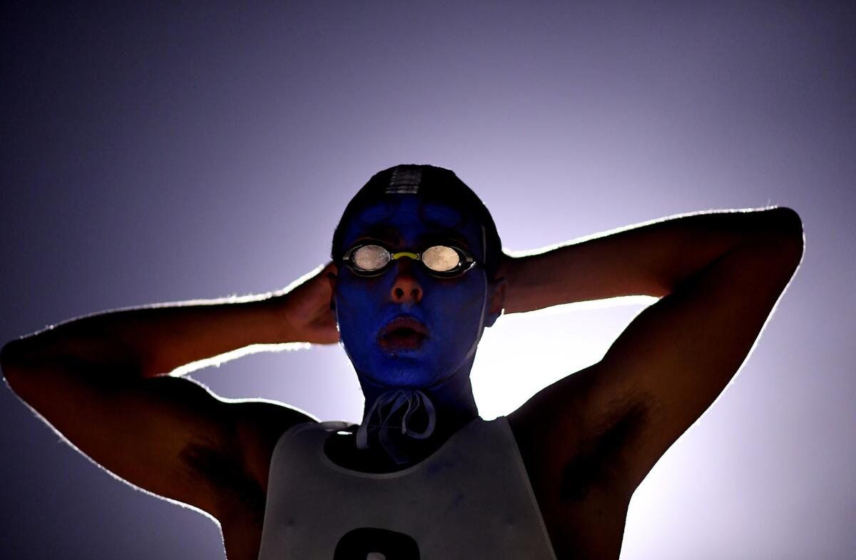 A lifeguard prepares to enter the water.