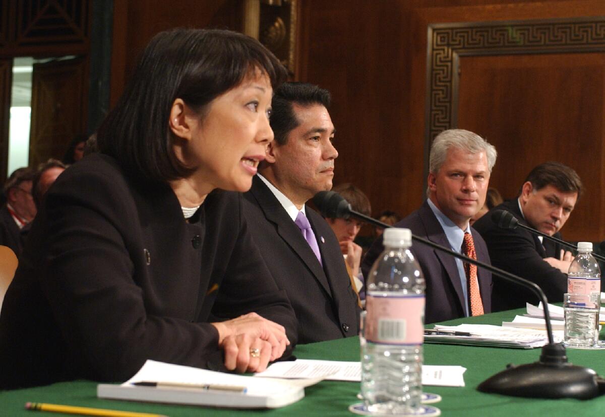 Former U.S. Attorneys Carol Lam, left, testifies before the Senate Judiciary Committee hearing