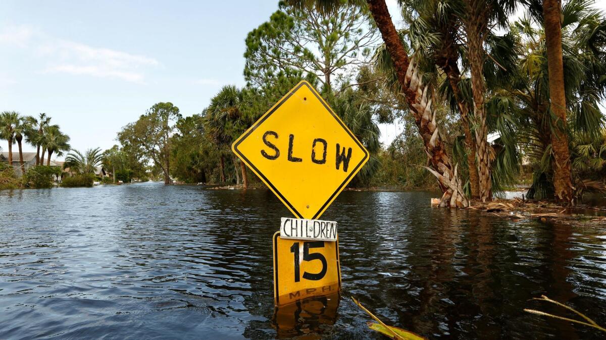 In Bonita Springs, Fla., floodwaters reached waist deep in some areas, flooding homes and cars. (Carolyn Cole / Los Angeles Times)