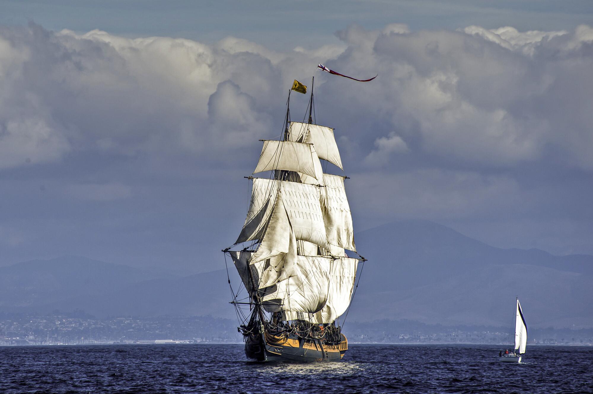 A wide view of the tall ship under sail.