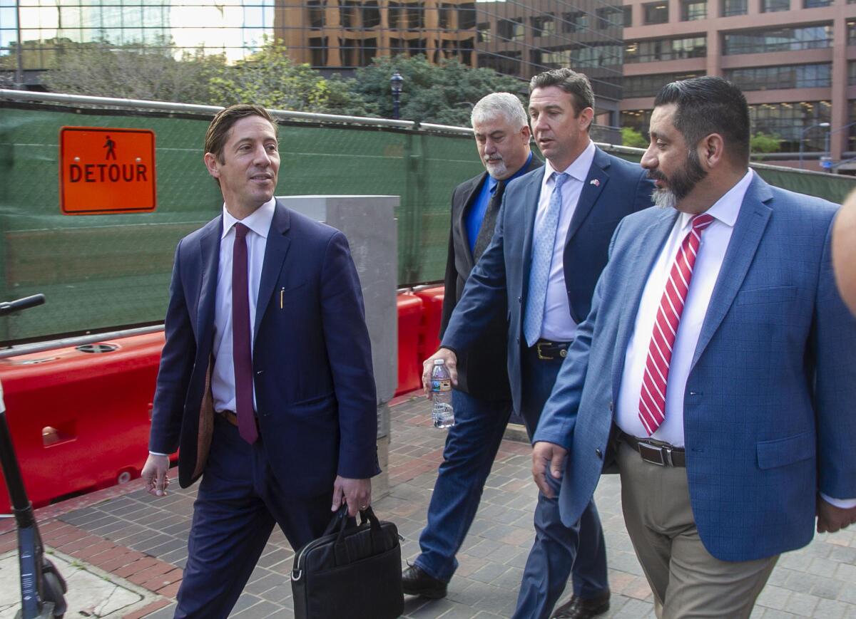 Former U.S. Rep. Duncan Hunter, second from right, leaves the federal courthouse in San Diego. 