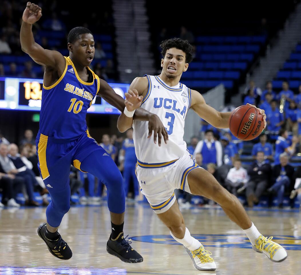 UCLA guard Jules Bernard drives down the key against San Jose State guard Omari Moore.