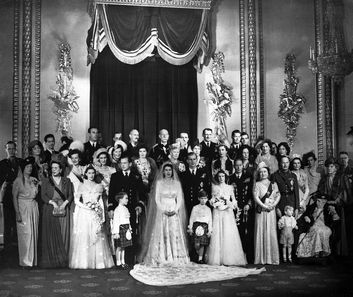 The newlyweds pose with royal guests at Buckingham Palace.