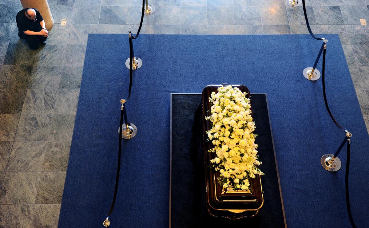 A man prays at the casket of former First Lady Nancy Reagan at the Reagan Presidential Library in Simi Valley.