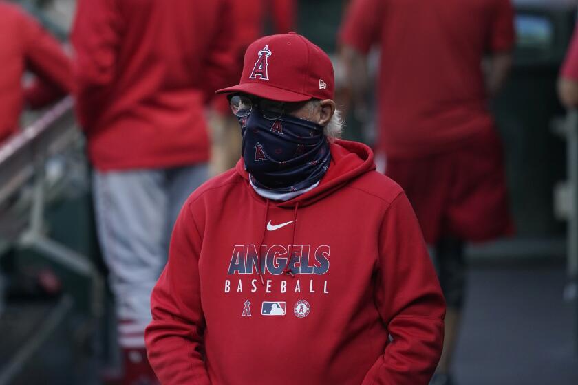 Los Angeles Angels manager Joe Maddon walks in the dugout before a baseball game between the San Francisco Giants and the Angels in San Francisco, Wednesday, Aug. 19, 2020. (AP Photo/Jeff Chiu)
