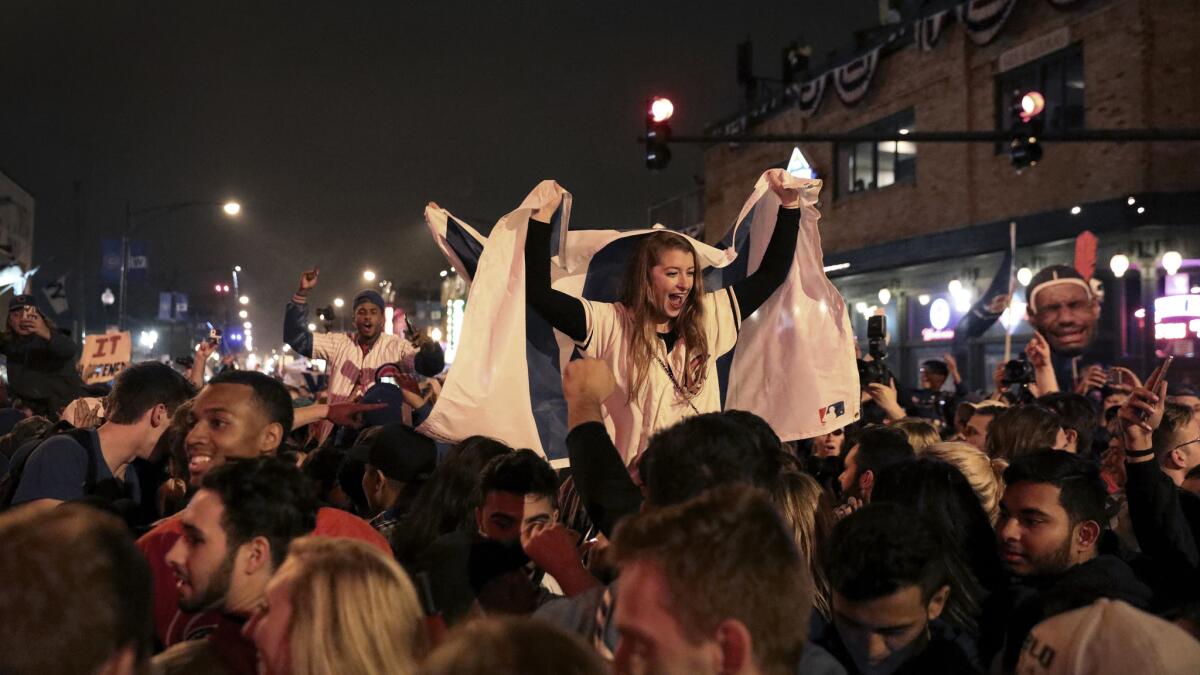 Fans cheer outside Wrigley Field after the Chicago Cubs defeated the Cleveland Indians in Game 7 to win the World Series on Nov. 3, 2016.