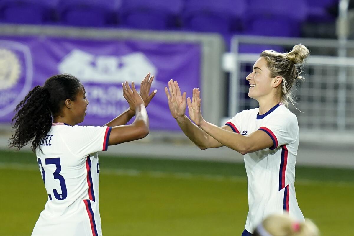 U.S. midfielder Kristie Mewis, right, celebrates with defender Margaret Purce.