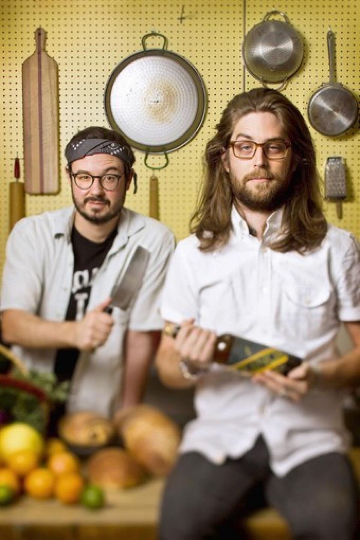 Evan George, left, and Alex Brown in Evan's kitchen. Their food blog is called Hot Knives.