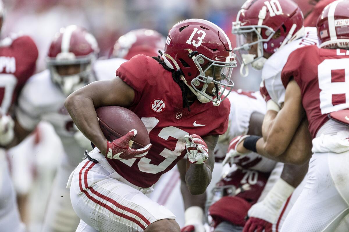 FILE - Alabama running back Jahmyr Gibbs (13) runs the ball during the first half of Alabama's A-Day NCAA college football scrimmage on April 16, 2022, in Tuscaloosa, Ala. Gibbs gained 5.2 yards per carry each of his two seasons at Georgia Tech and had a combined 1,206 yards rushing and 773 yards receiving during that stretch. He now figures to have a featured role for Alabama, which had two running backs selected in the first round and two more taken in the third round over the last four drafts. (AP Photo/Vasha Hunt, File)