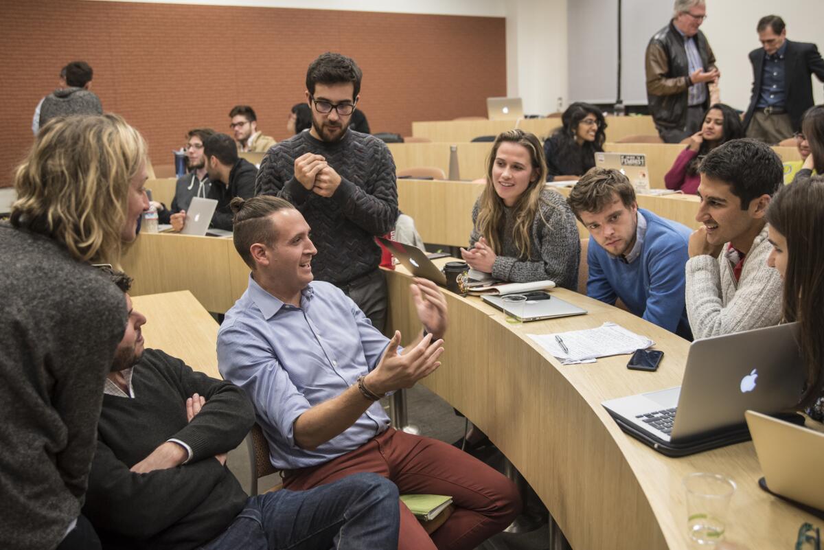Zvika Krieger, center, an instructor of Hacking 4 Diplomacy at Stanford University, speaks to students during one of the final classes of the semester.