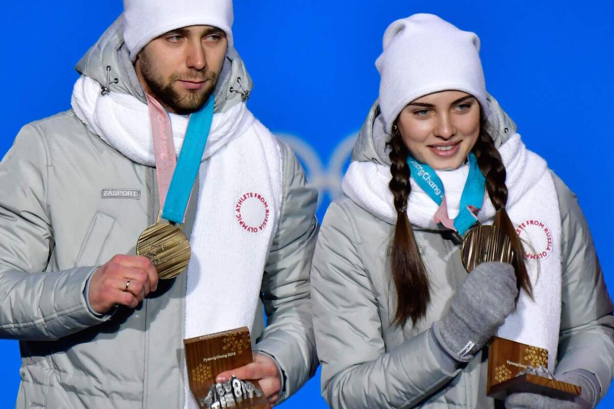 Alexander Krushelnitsky and Anastasia Bryzgalova pose with their bronze medals in curling on Feb. 14.