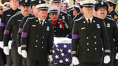 Pallbearers lead the casket of fallen firefighter Glenn Allen into the Cathedral of Our Lady of the Angels for his funeral service. Allen was mortally injured while battling a house fire in the Hollywood Hills the night of Feb. 16.