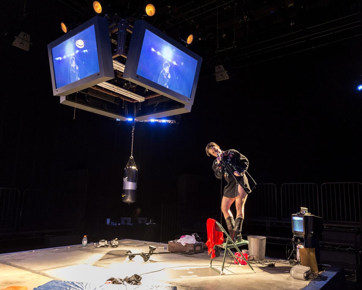 "The Wholehearted" plays out in a boxing ring topped with monitors playing or recorded material or video shot live. (Craig Schwartz)