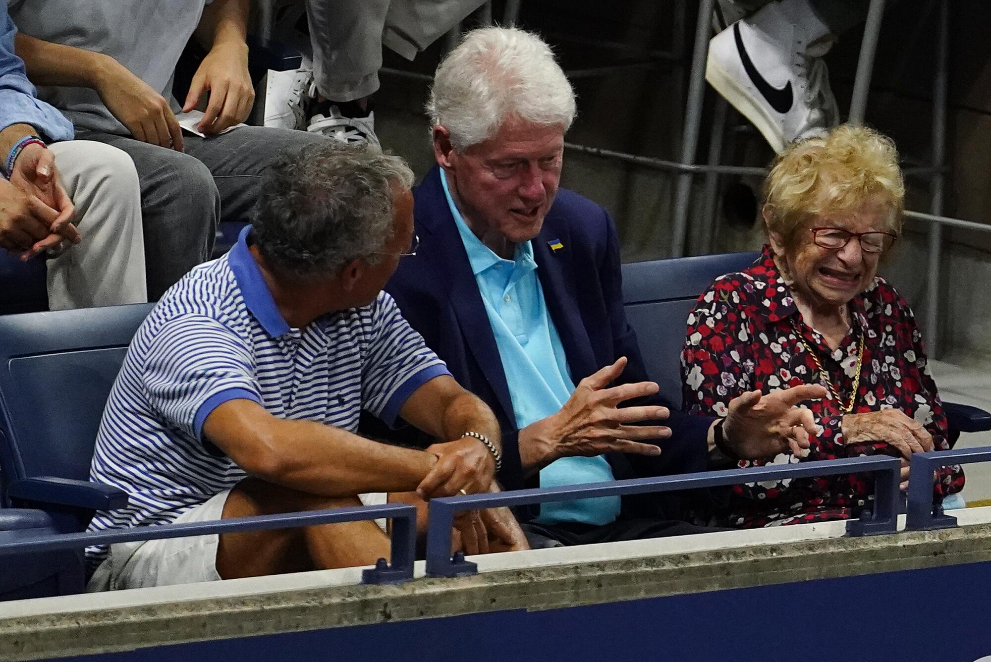 Former President Bill Clinton and Ruth Westheimer watch the match between Serena Williams and Danka Kovinic.