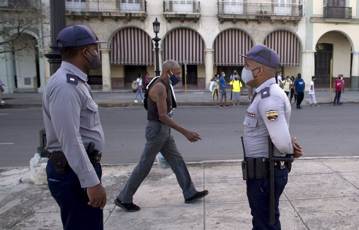 Police stand guard near the National Capitol building in Havana, Cuba, Monday, July 12, 2021, the day after protests against food shortages and high prices amid the coronavirus crisis. (AP Photo/Ismael Francisco)