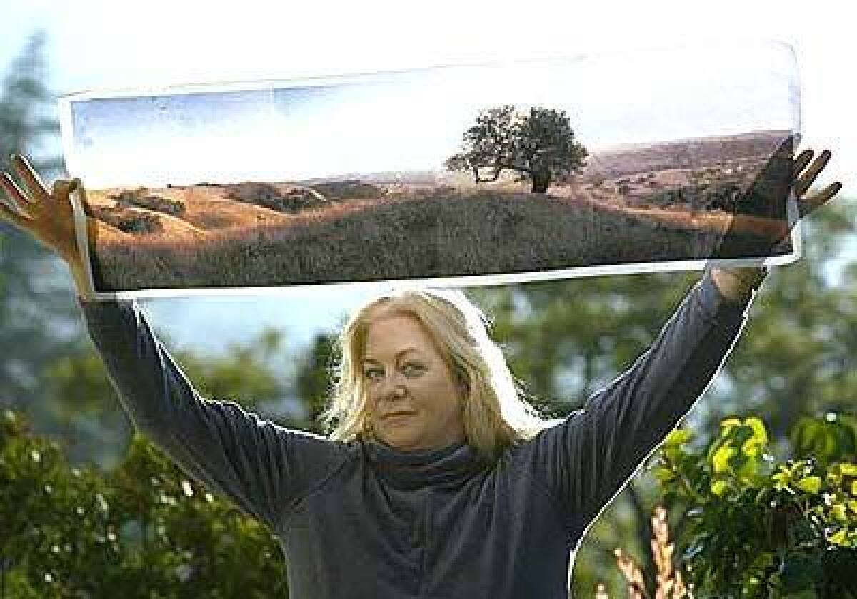 Production designer Jane Ann Stewart holds a photograph of a picnic location used in Sideways.