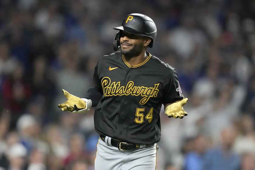 Pittsburgh Pirates' Joshua Palacios reacts toward teammates in the dugout after his pinch-hit, three-run home run off Chicago Cubs relief pitcher Julian Merryweather during the ninth inning of a baseball game Thursday, Sept. 21, 2023, in Chicago. (AP Photo/Charles Rex Arbogast)