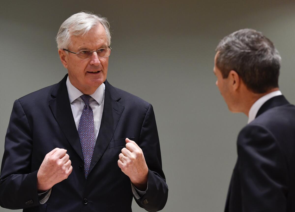 European Union's chief Brexit negotiator Michel Barnier speaks with Ambassador Michael Clauss.