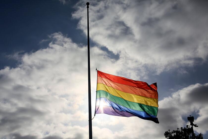 TOPSHOT - A pride flag stands a half mast during a memorial service in San Diego, California on June 12, 2016, for the victims of the Orlando Nighclub shooting. Fifty people died when a gunman allegedly inspired by the Islamic State group opened fire inside a gay nightclub in Florida, in the worst terror attack on US soil since September 11, 2001. / AFP / Sandy Huffaker (Photo credit should read SANDY HUFFAKER/AFP via Getty Images)