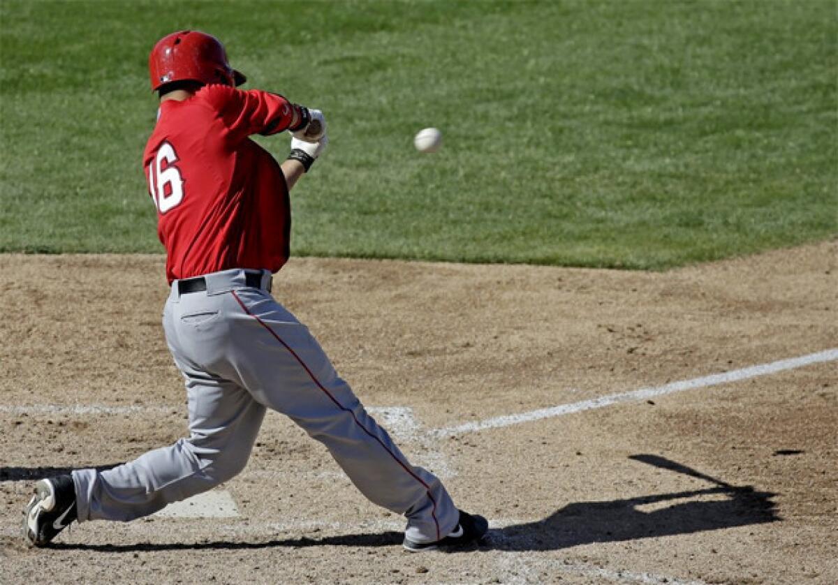 Angels catcher Hank Conger hits a two-run single during the sixth inning of an exhibition game against the Milwaukee Brewers.