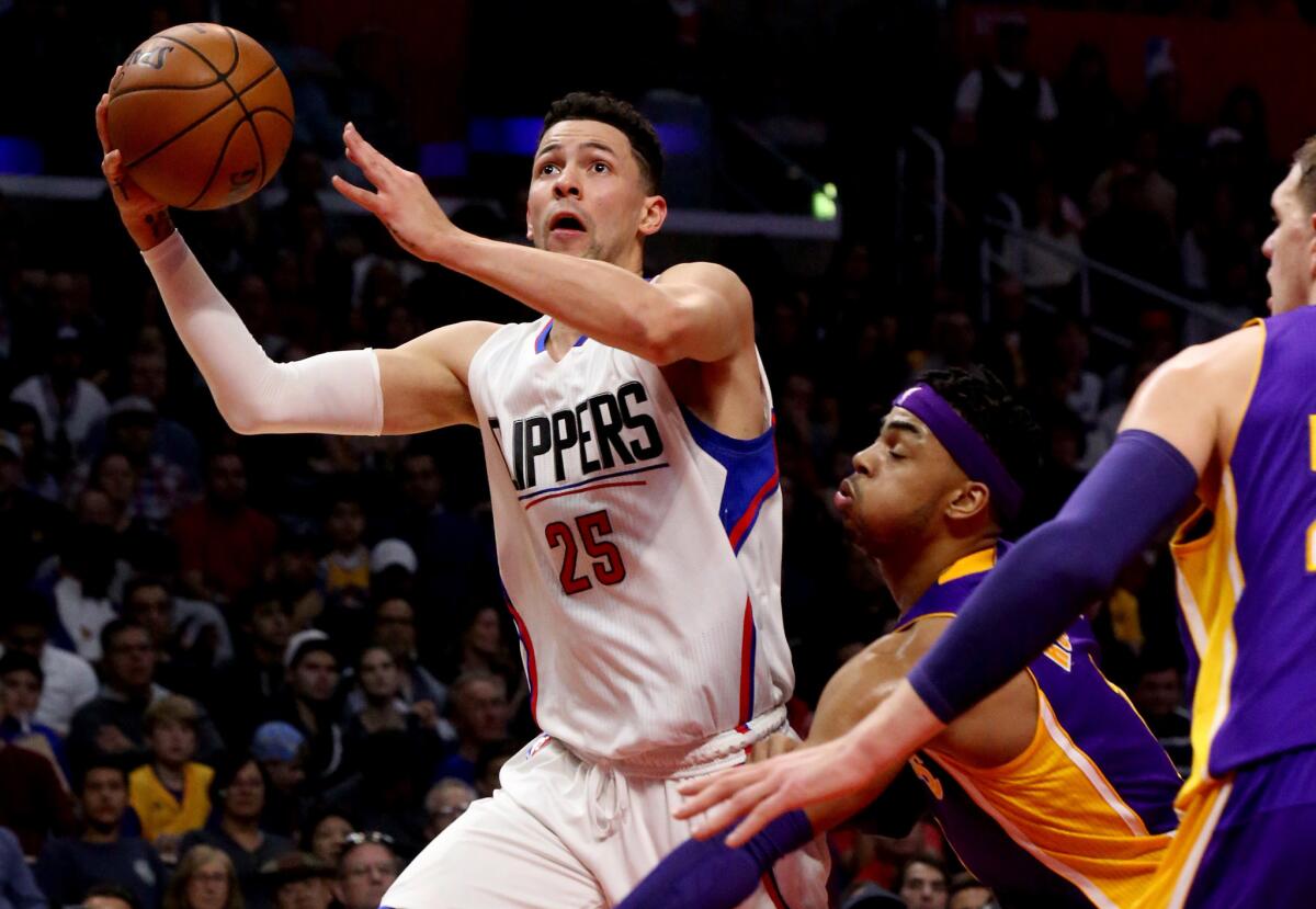 Clippers guard Austin Rivers drives down the lane for a layup against Lakers guard D'Angelo Russell during the first half of Saturday's game.